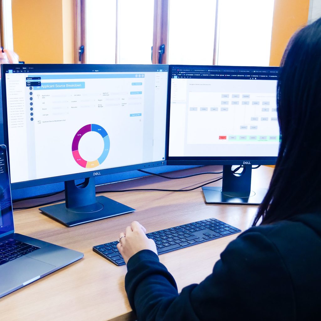 Employee reviewing data on their monitors