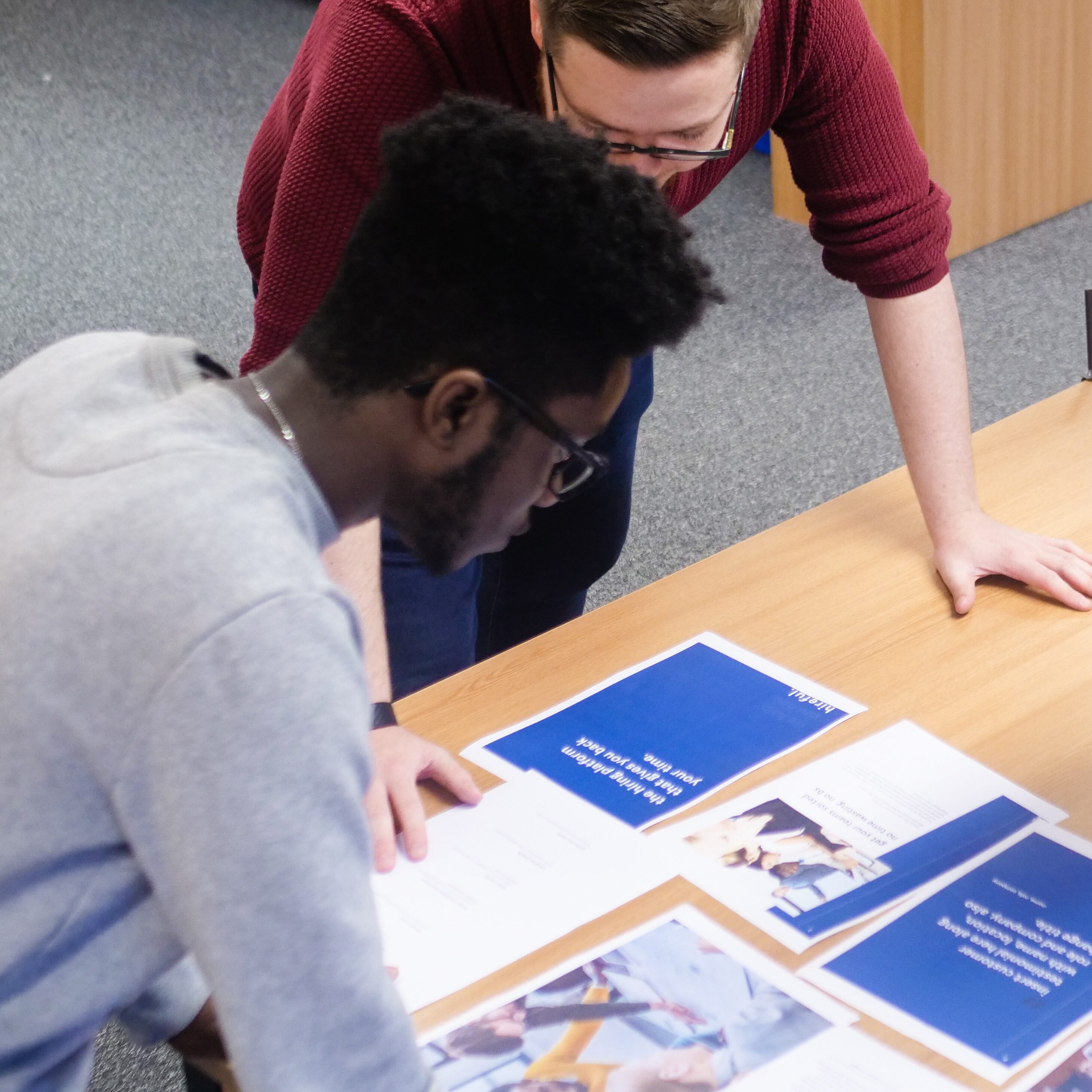 Two employees discussing their work