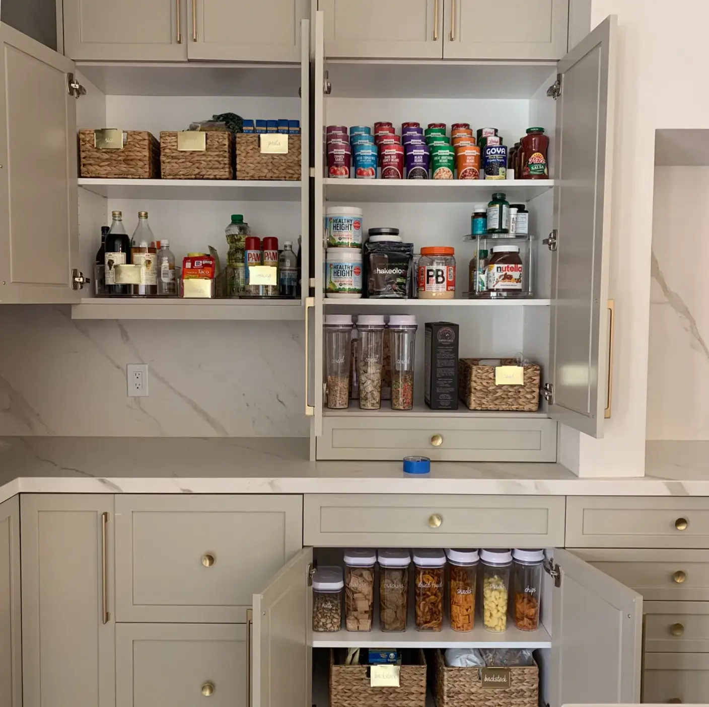 organized pantry with rattan baskets and can organization