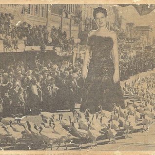 Promotional Card For The 1947 Cuero Turkey Trot. The Girl Is Miss Beverly Bell, Miss Turkey Trot, Who Is Wearing An All Turkey Feather Dress. This Title Was Most Likely Created To Promote The Trot Leading Up To November.