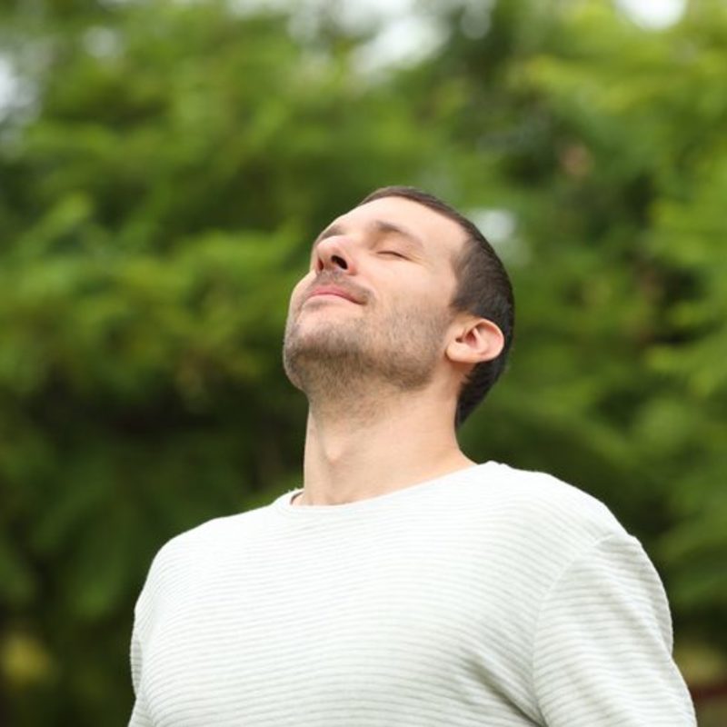 young adult male breathing in fresh air