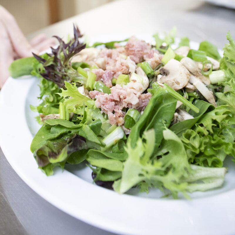 Mockingbird Hill resident taking lunch from cafeteria