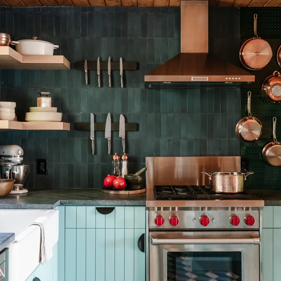 julia childs inspired kitchen design with blue, copper and red details